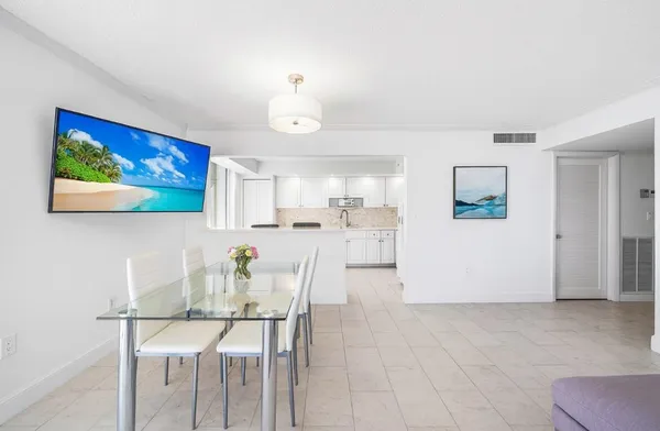 a kitchen with granite countertop white cabinets and white stainless steel appliances