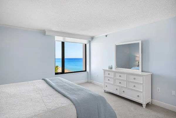a spacious bedroom with a bed and a window