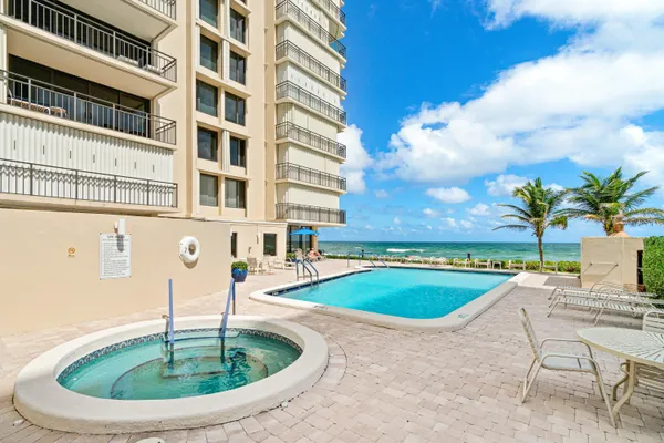 a view of swimming pool with outdoor seating