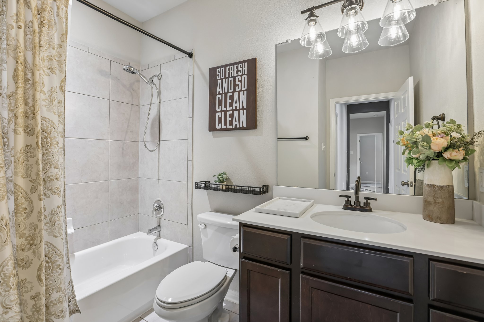 6801 Banff Cove Austin, TX 78754 - Photo 26 of 37 Hall bathroom with tub/shower combo and quartz countertops and a large mirror.
