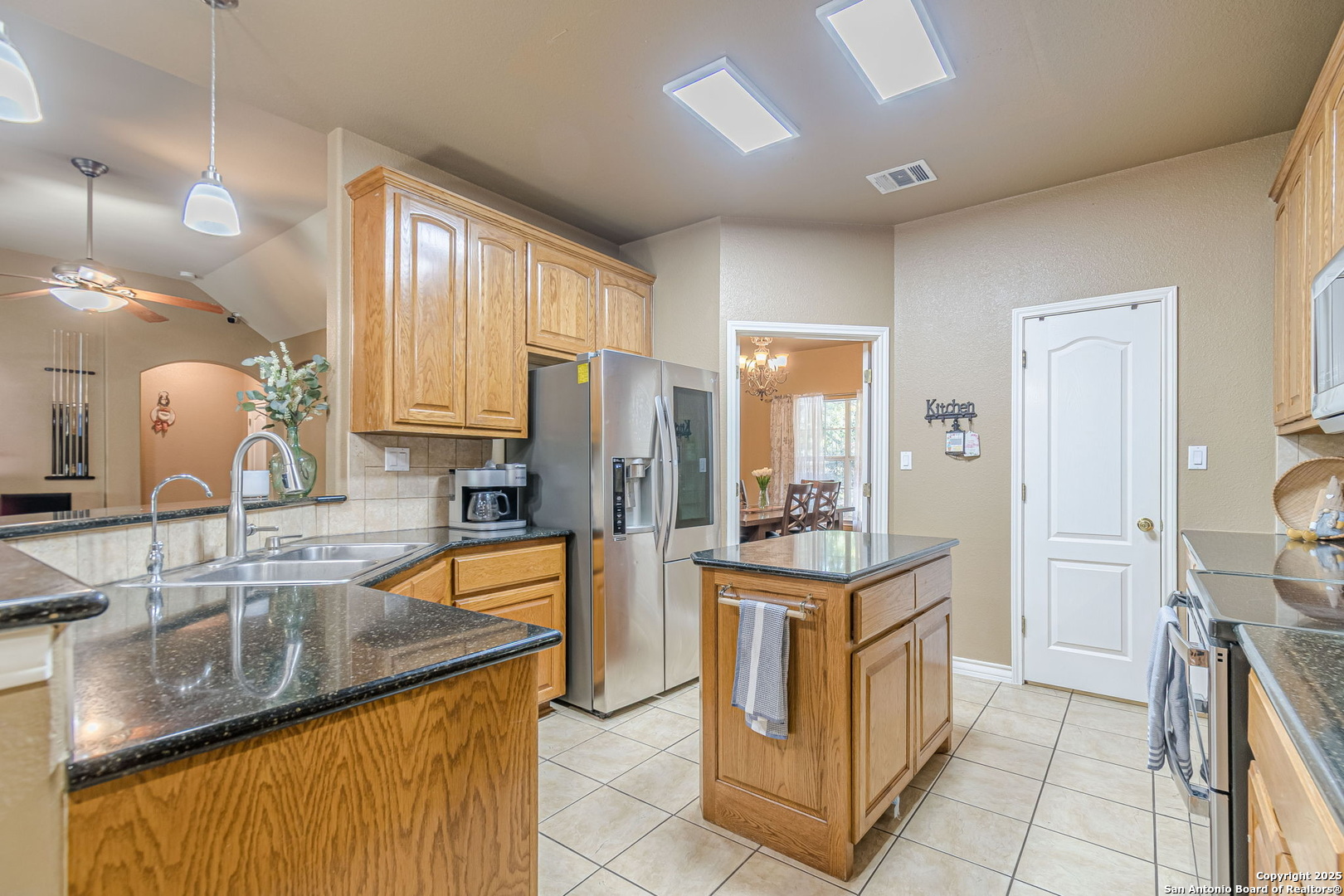 249 Lakeridge Loop Lakehills, TX 78063 - Photo 11 of 50 a kitchen with stainless steel appliances granite countertop a stove and a sink