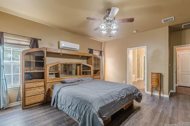 a view of a closet area with wooden floor