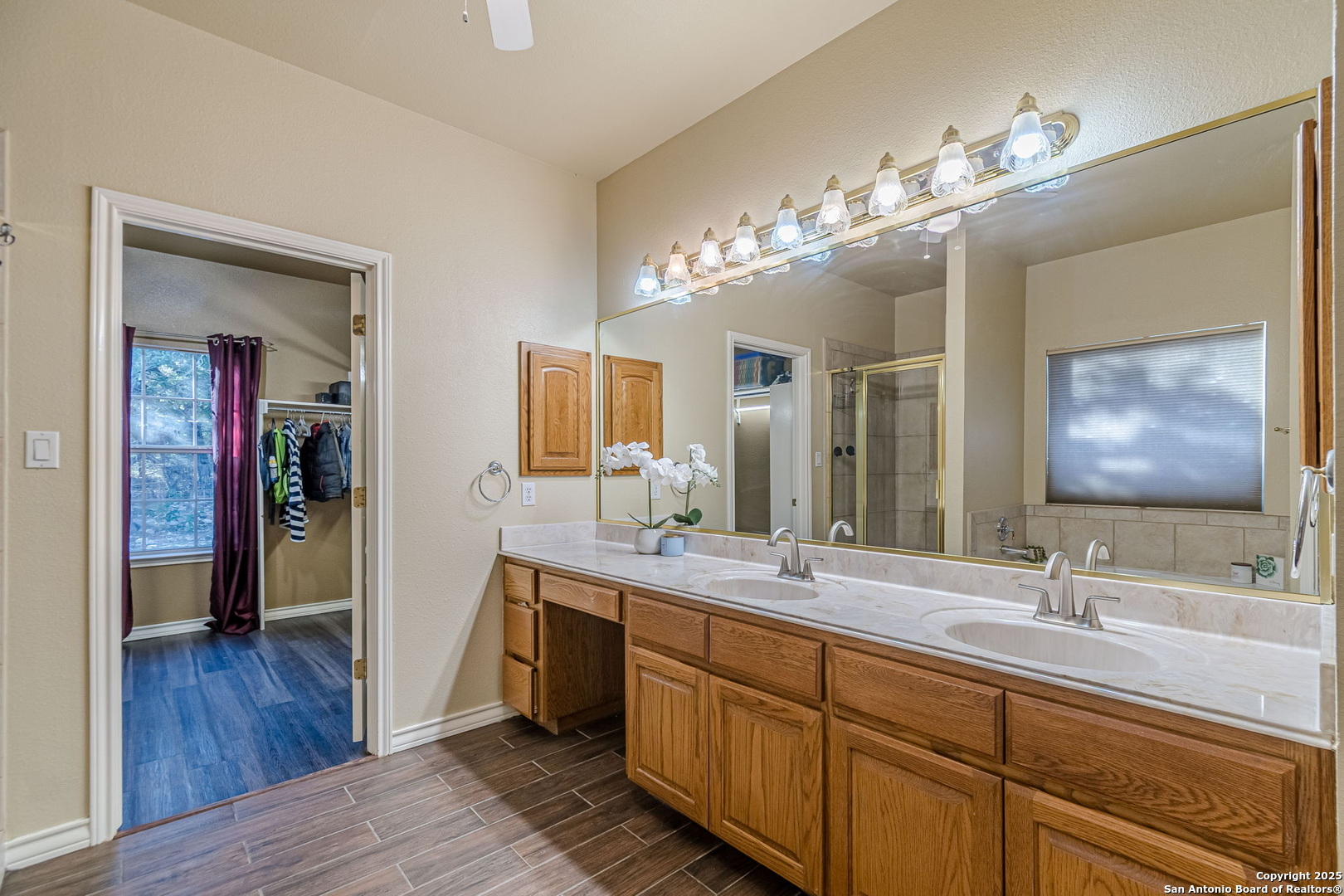 249 Lakeridge Loop Lakehills, TX 78063 - Photo 18 of 50 a spacious bathroom with a double vanity sink and a mirror