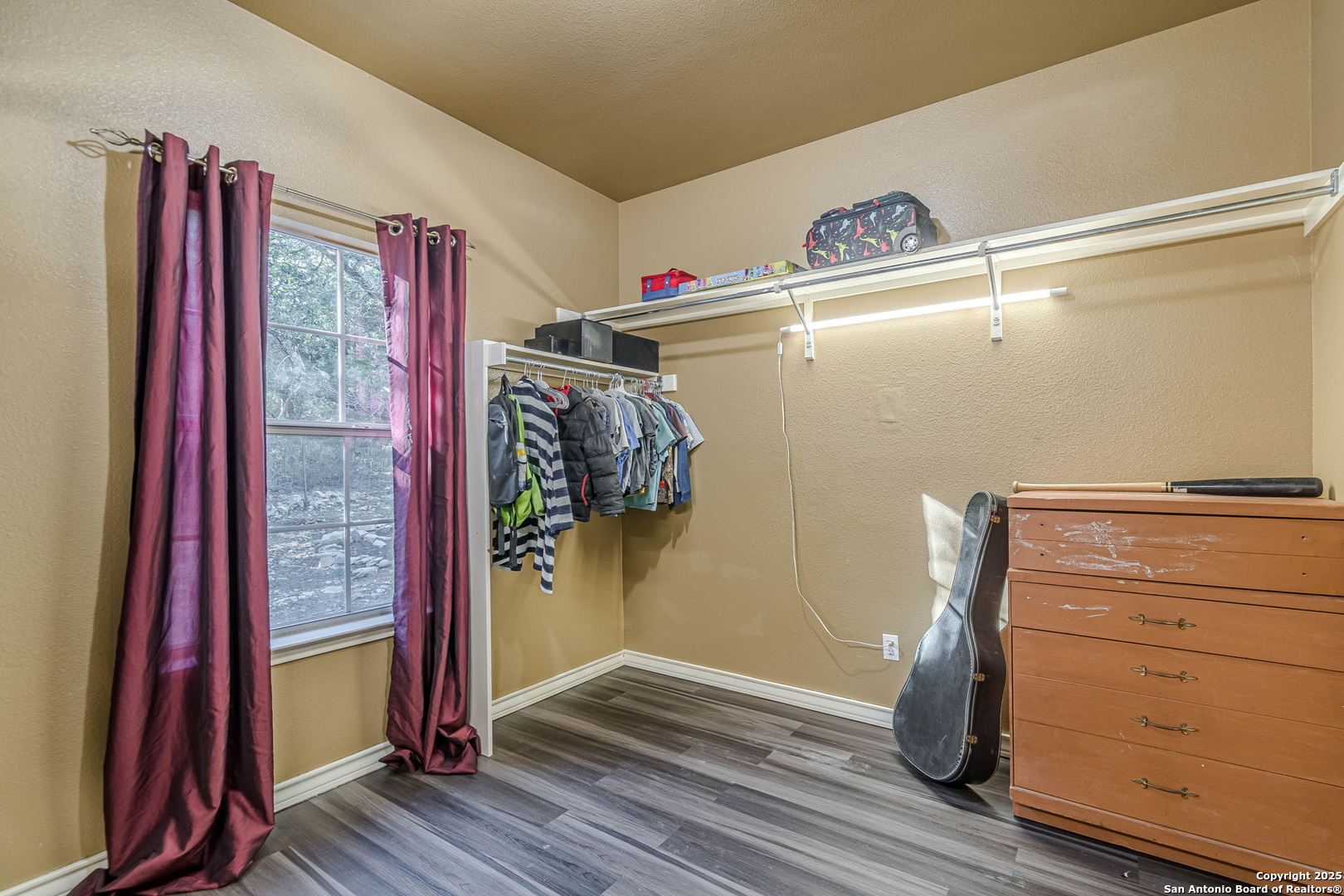 249 Lakeridge Loop Lakehills, TX 78063 - Photo 19 of 50 a view of a closet area with wooden floor