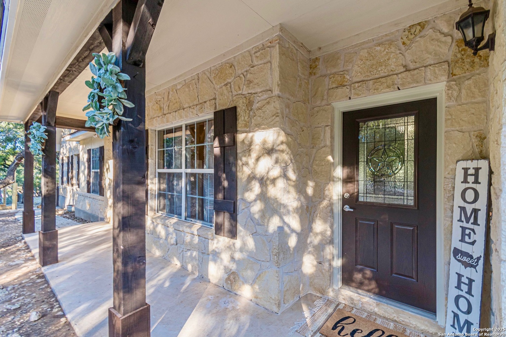 249 Lakeridge Loop Lakehills, TX 78063 - Photo 2 of 50 a view of a brick house with a large windows