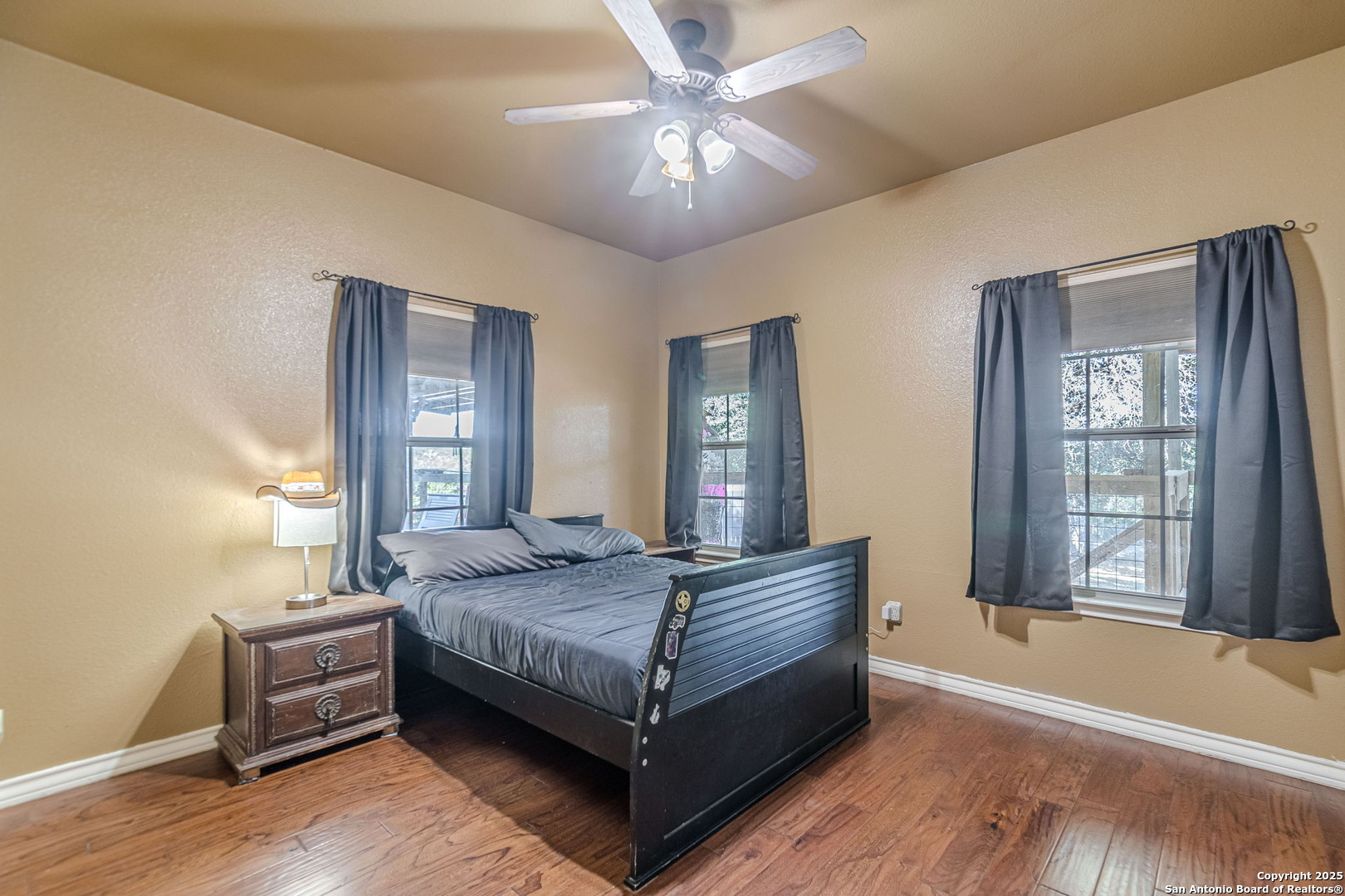 249 Lakeridge Loop Lakehills, TX 78063 - Photo 22 of 50 a bedroom with a bed and a chandelier