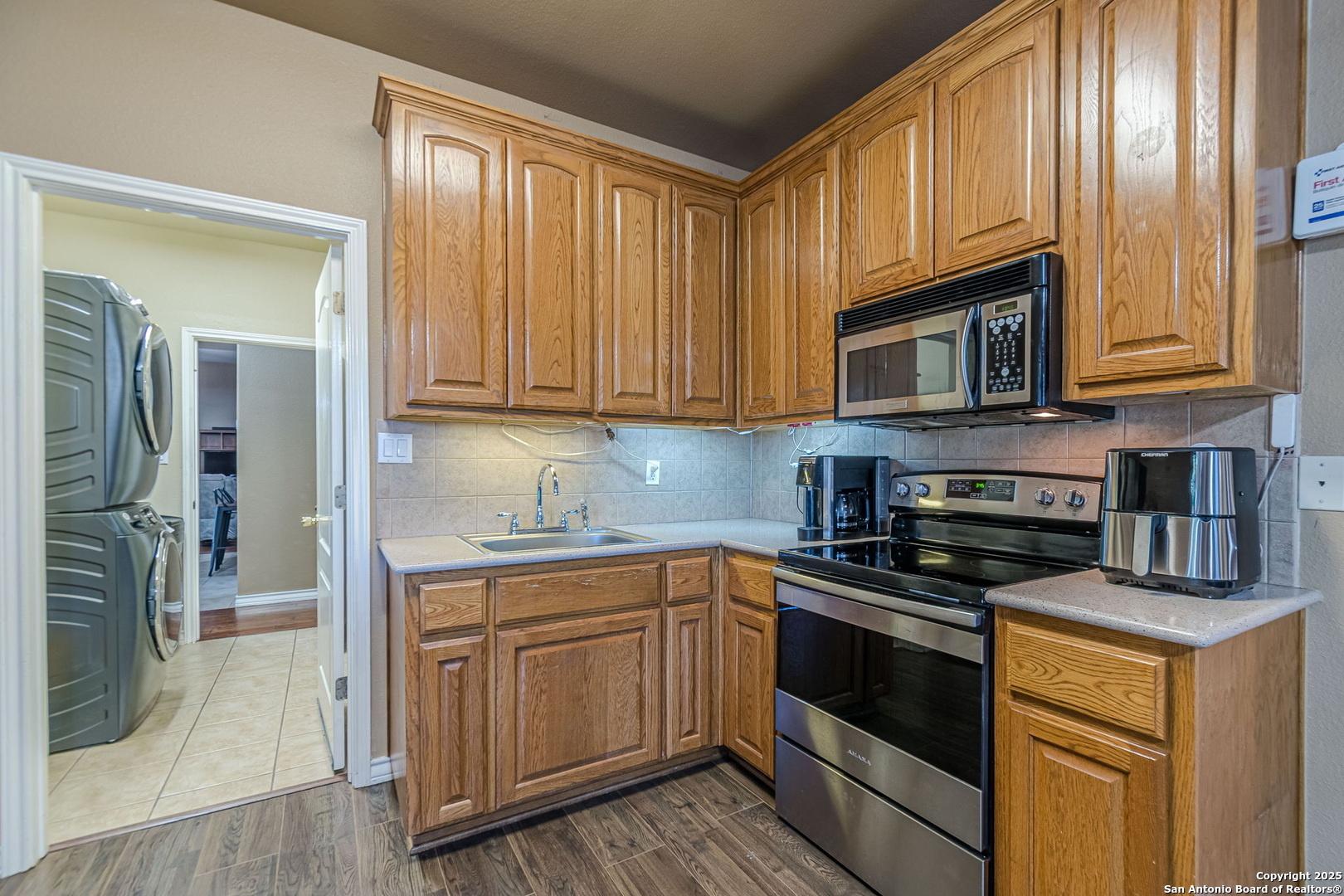 249 Lakeridge Loop Lakehills, TX 78063 - Photo 28 of 50 a kitchen with stainless steel appliances granite countertop a stove microwave and cabinets