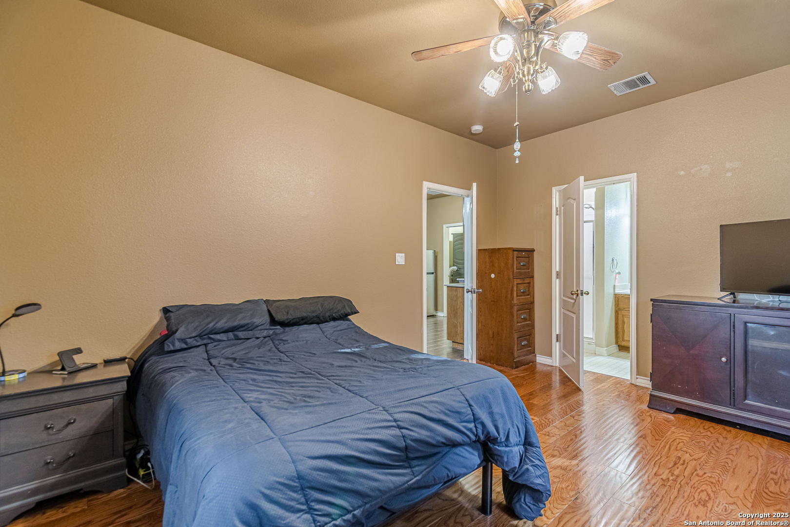 249 Lakeridge Loop Lakehills, TX 78063 - Photo 32 of 50 a bedroom with a bed and a flat screen tv