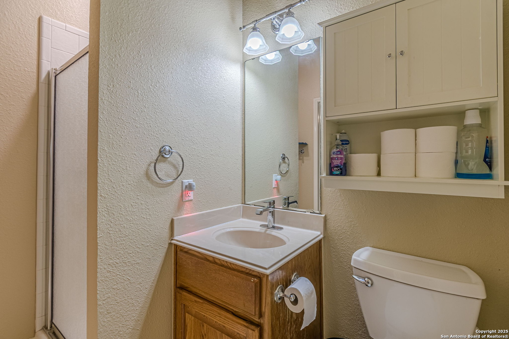 249 Lakeridge Loop Lakehills, TX 78063 - Photo 33 of 50 a bathroom with a sink a toilet and mirror