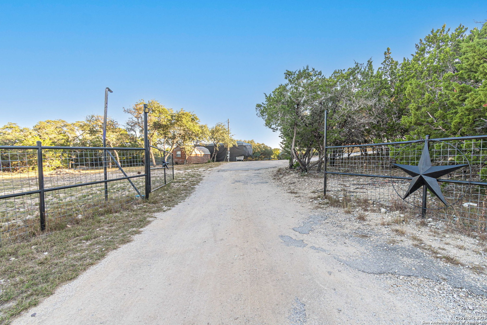 249 Lakeridge Loop Lakehills, TX 78063 - Photo 41 of 50 a view of a yard with wooden fence