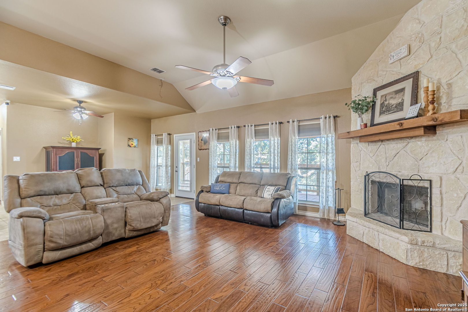 249 Lakeridge Loop Lakehills, TX 78063 - Photo 8 of 50 a living room with furniture and a fireplace