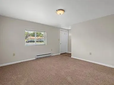 an empty room with windows and closet