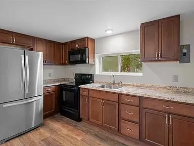 a kitchen with a sink stove and refrigerator