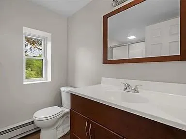 a bathroom with a sink a toilet and a mirror