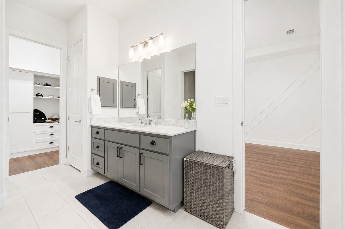 629 Germander Road Leander, TX 78641 - Photo 16 of 38 a bathroom with a double vanity sink a mirror and a bathtub