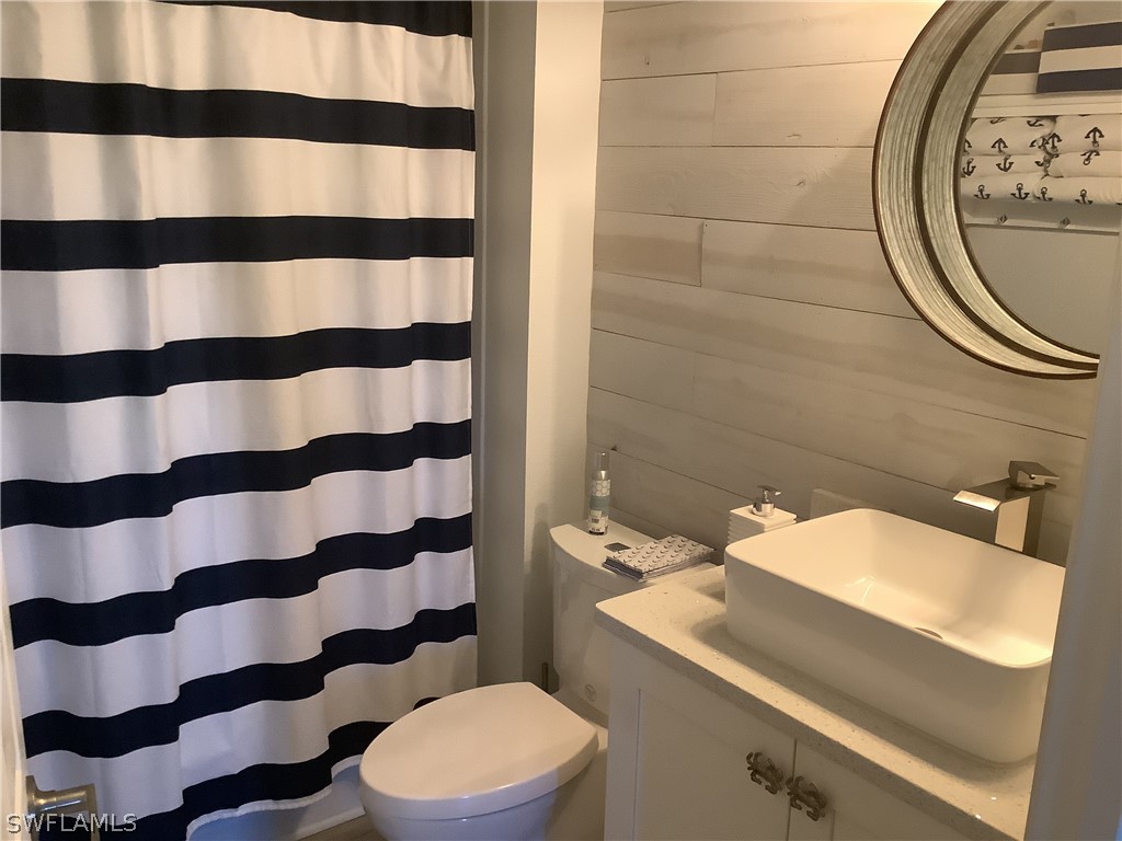 2642 York Road St. James City, FL 33956 - Photo 9 of 14 a bathroom with a sink a toilet and a mirror