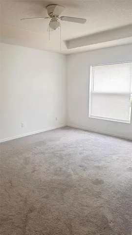 a bathroom with a granite countertop bathtub shower sink vanity and toilet