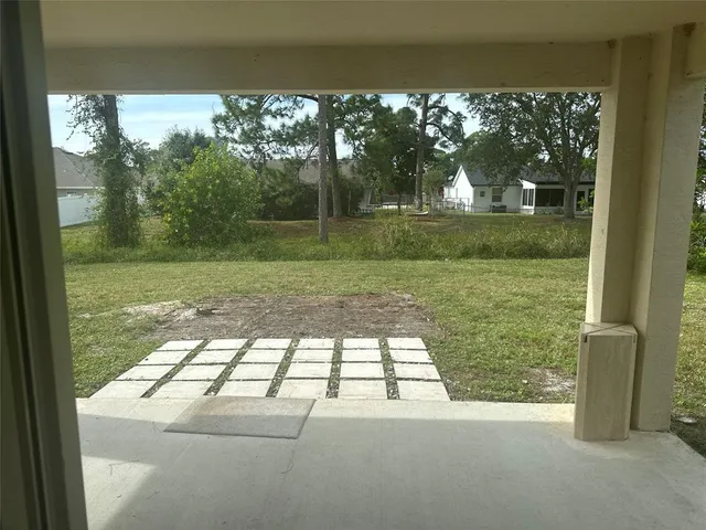 a view of empty room with floor to ceiling windows