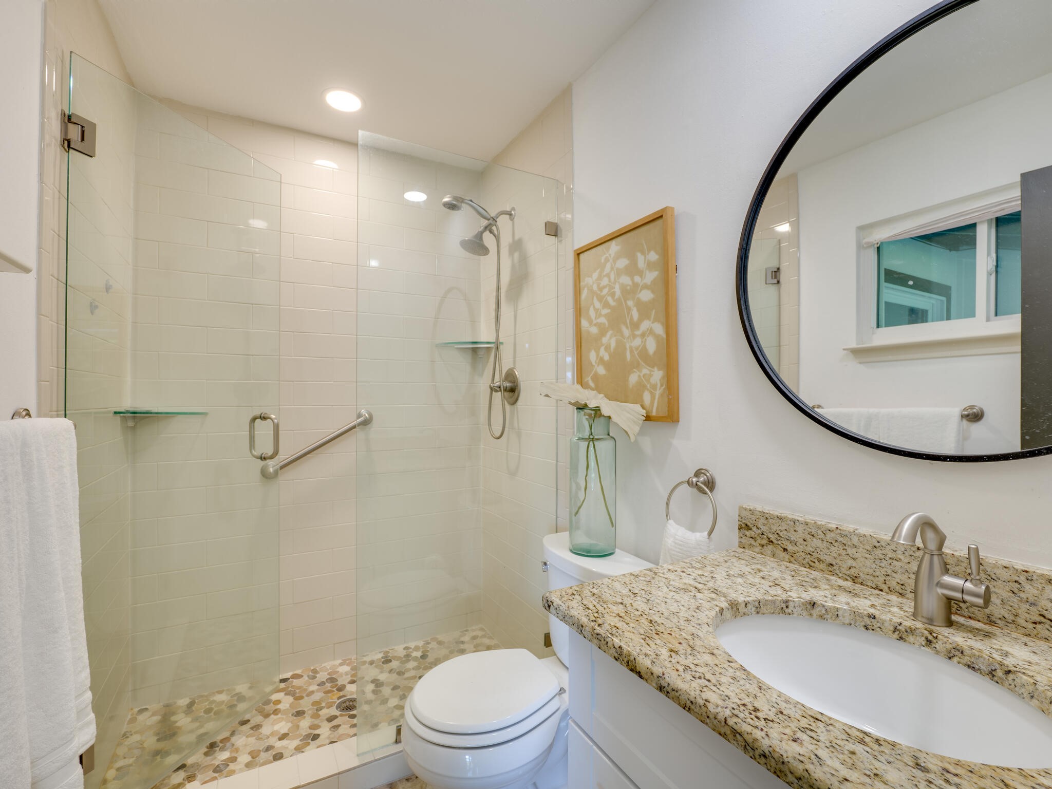 3203 Foster Lane Austin, TX 78757 - Photo 20 of 37 Tastefully updated and neutral primary bath has a frameless shower door, built in nooks, and granite counters.