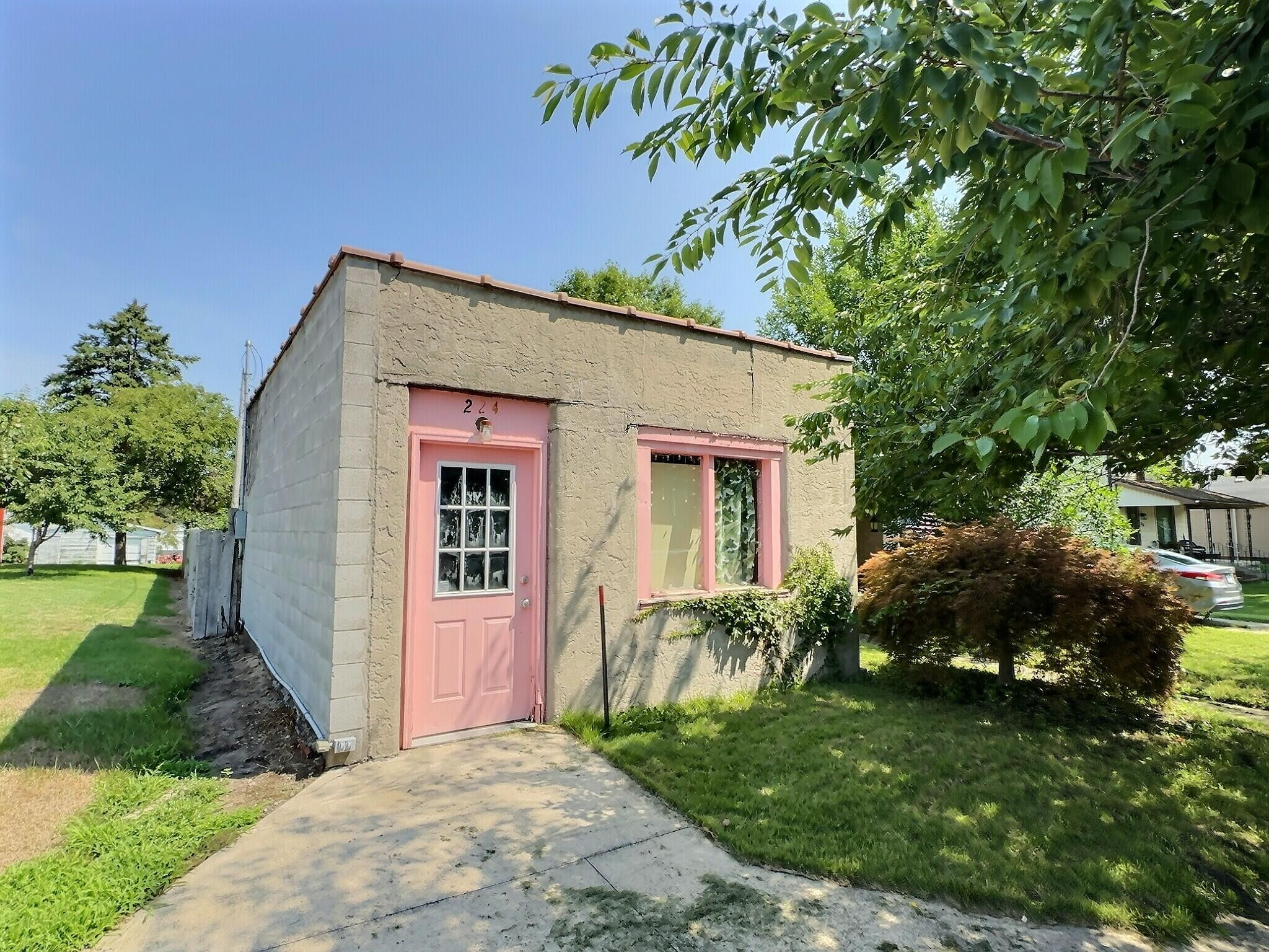 224 East State Street Morocco, IN 47963 - Photo 2 of 17 a front view of house with a garden