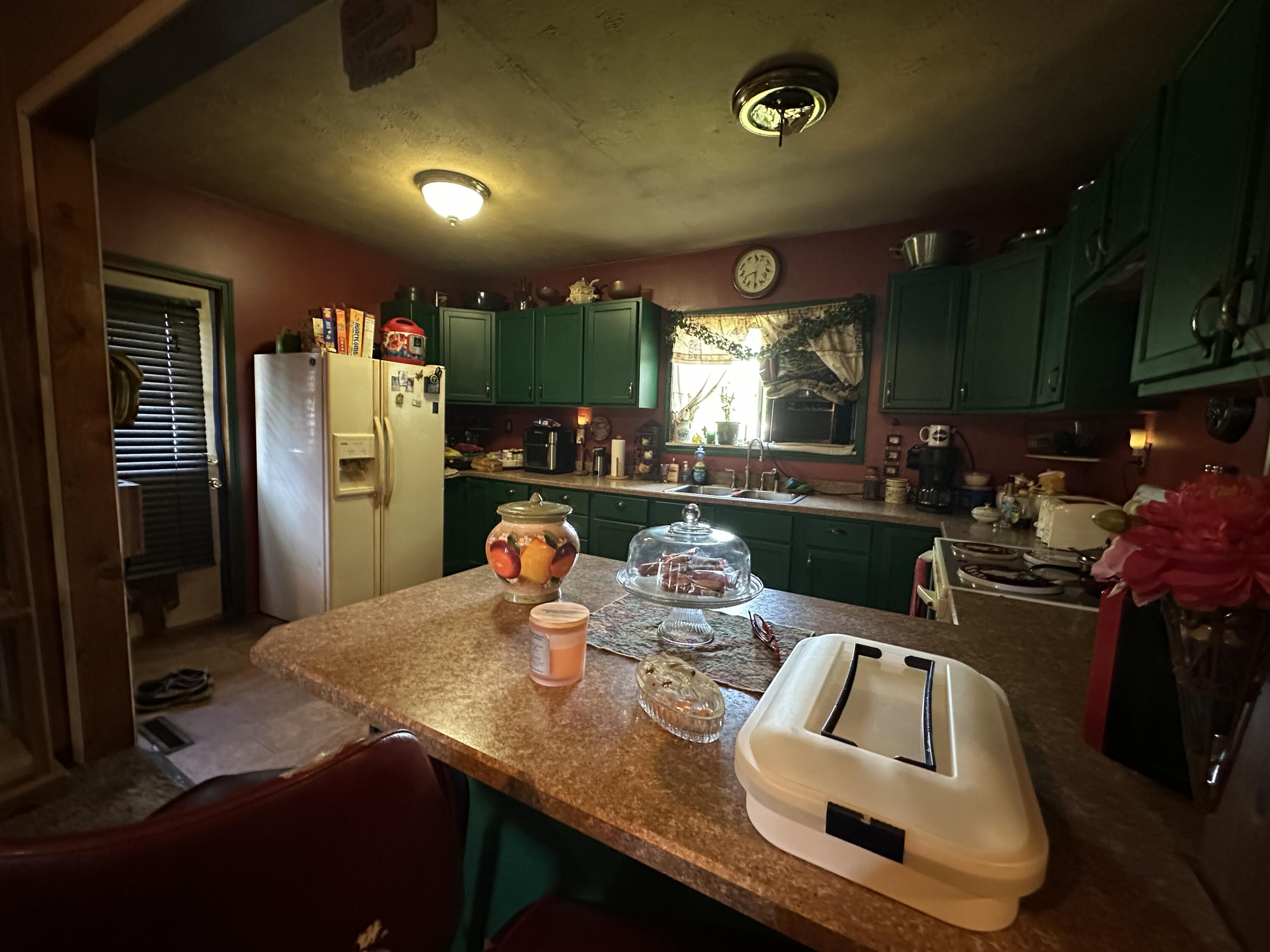 224 East State Street Morocco, IN 47963 - Photo 3 of 17 a kitchen with sink refrigerator and outdoor view