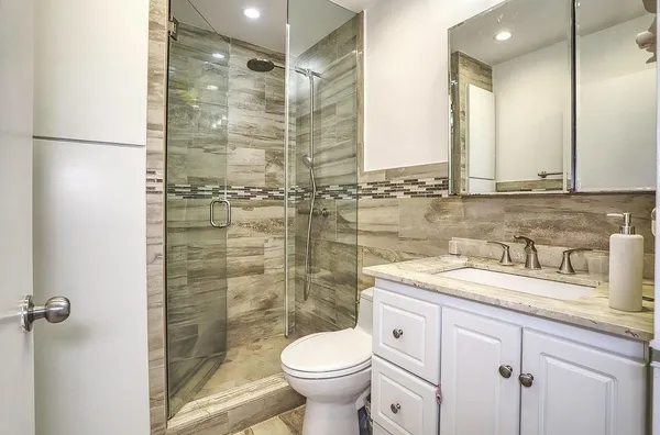 a bathroom with a sink toilet and shower