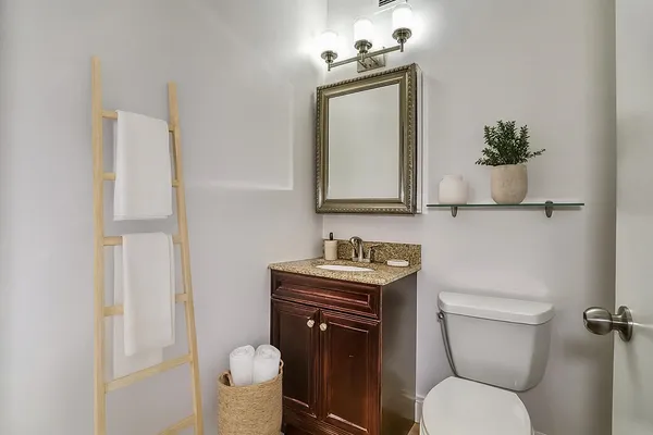 a bathroom with a toilet sink and mirror