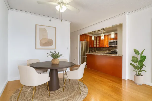 a dining room with furniture and wooden floor