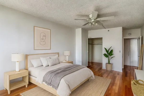 a bedroom with a bed and a chandelier