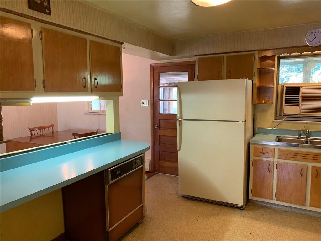 201 Highway 68 Rochester, PA 15074 - Photo 6 of 24 Fully equipped kitchen with dishwasher, eat-at counter, and door to the enclosed patio.