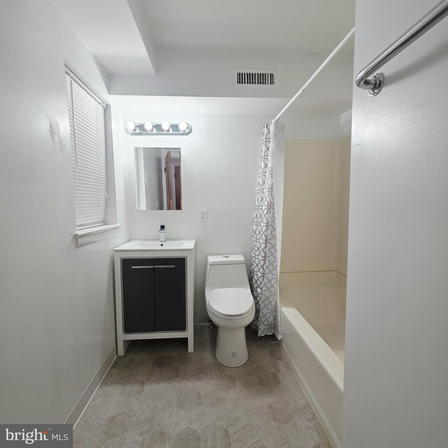 532 South 15th Street, Unit 2 Philadelphia, PA 19146 - Photo 10 of 11 a bathroom with a toilet sink and mirror