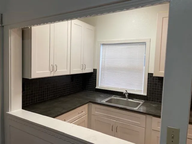 a kitchen with a sink and cabinets