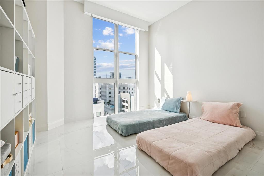 111 Southeast 8th Avenue, Unit 1005 Fort Lauderdale, FL 33301 - Photo 12 of 18 a bedroom with two beds and a large window