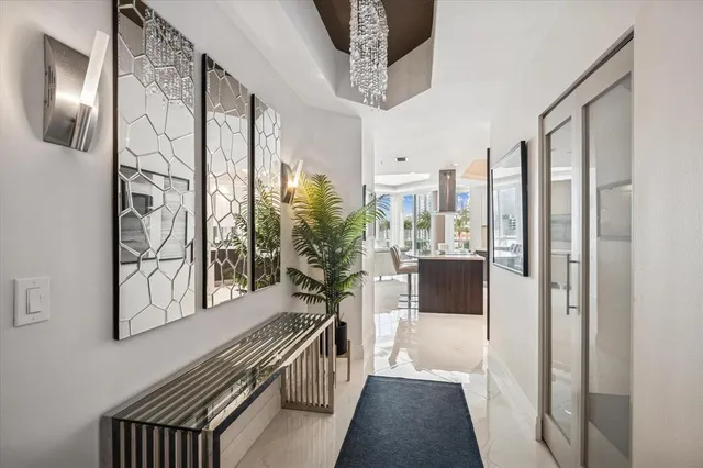 a view of a hallway and a livingroom with furniture