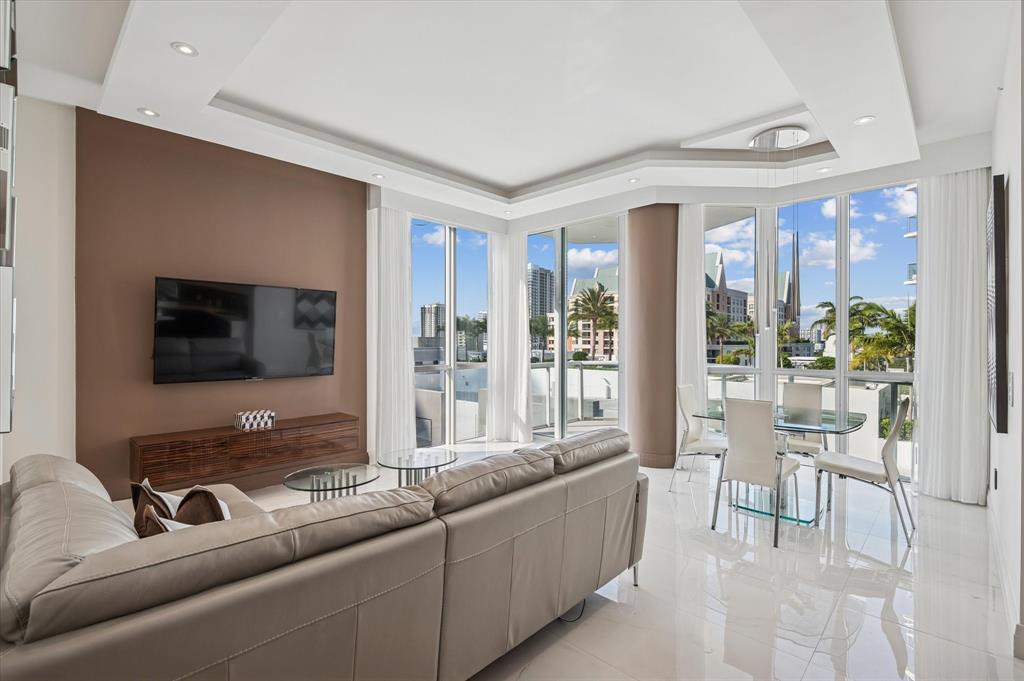 111 Southeast 8th Avenue, Unit 1005 Fort Lauderdale, FL 33301 - Photo 4 of 18 a living room with furniture and a flat screen tv