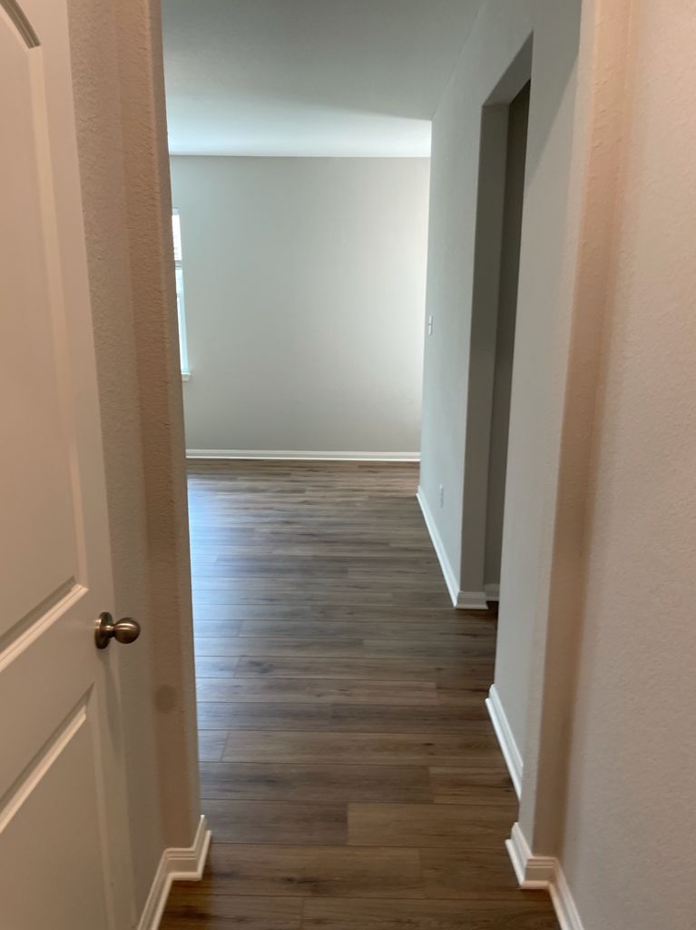 109 Declaration Lane Liberty Hill, TX 78642 - Photo 5 of 24 Corridor featuring baseboards and dark wood-style floors