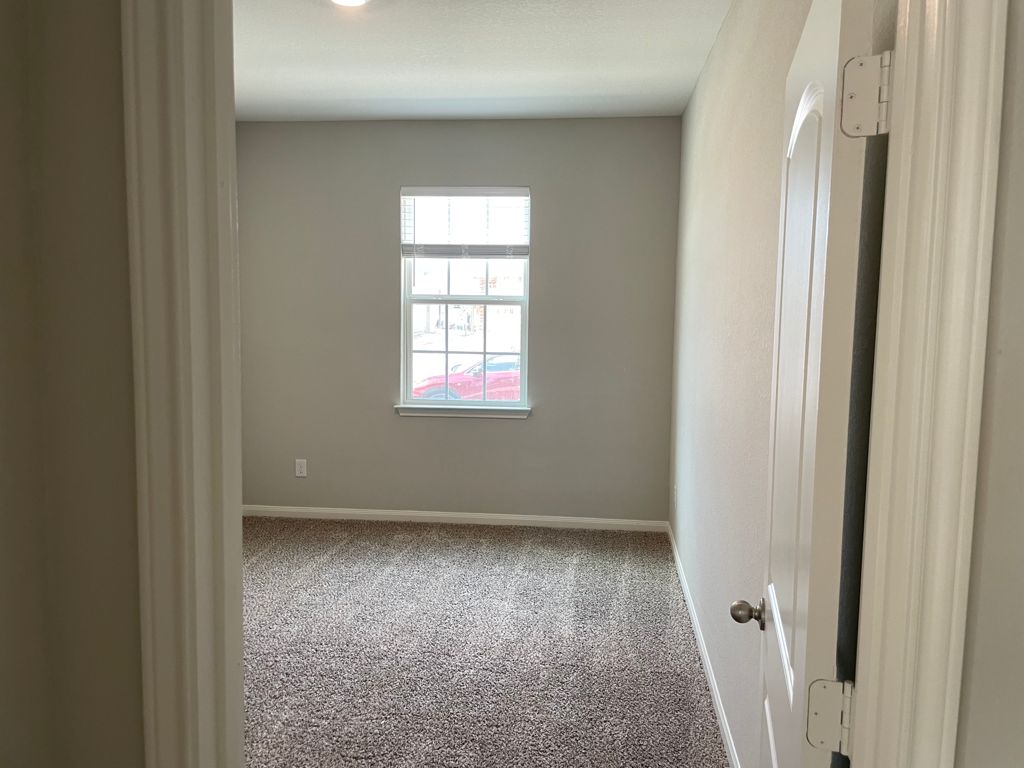 109 Declaration Lane Liberty Hill, TX 78642 - Photo 7 of 24 Empty room with light carpet and baseboards