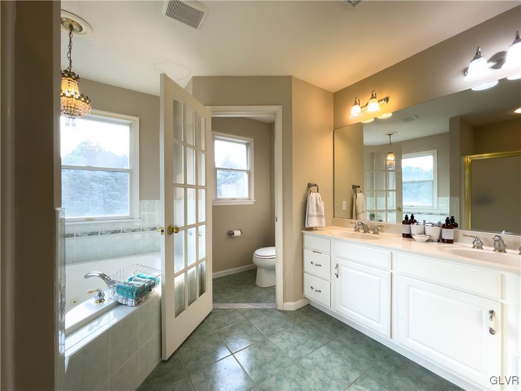 90 Mansfeld Road Hellertown, PA 18055 - Photo 44 of 50 a bathroom with a double vanity sink toilet and a tub