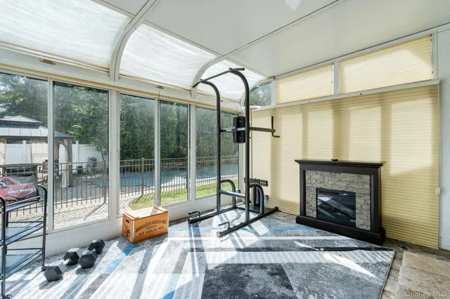 a living room with patio furniture and a fireplace