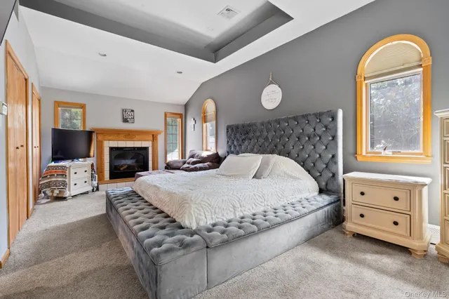 a spacious bedroom with a bed and a fireplace