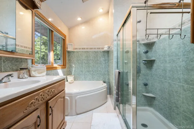 a bathroom with a granite countertop sink a toilet and shower