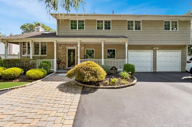 a front view of a house with a yard and seating space