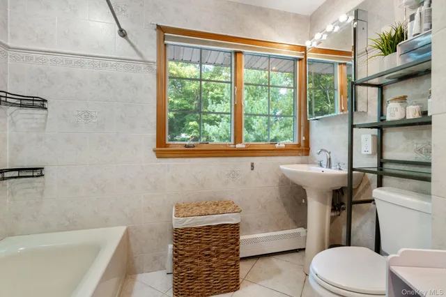 a bathroom with a sink a toilet and tub