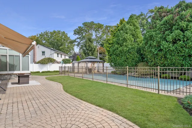 a view of a backyard with a garden and deck