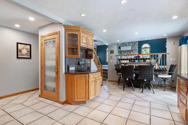 a view of kitchen with furniture and refrigerator