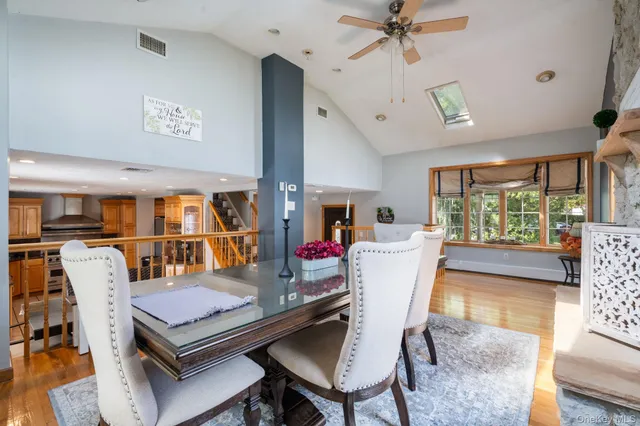 a dining room with furniture window and wooden floor