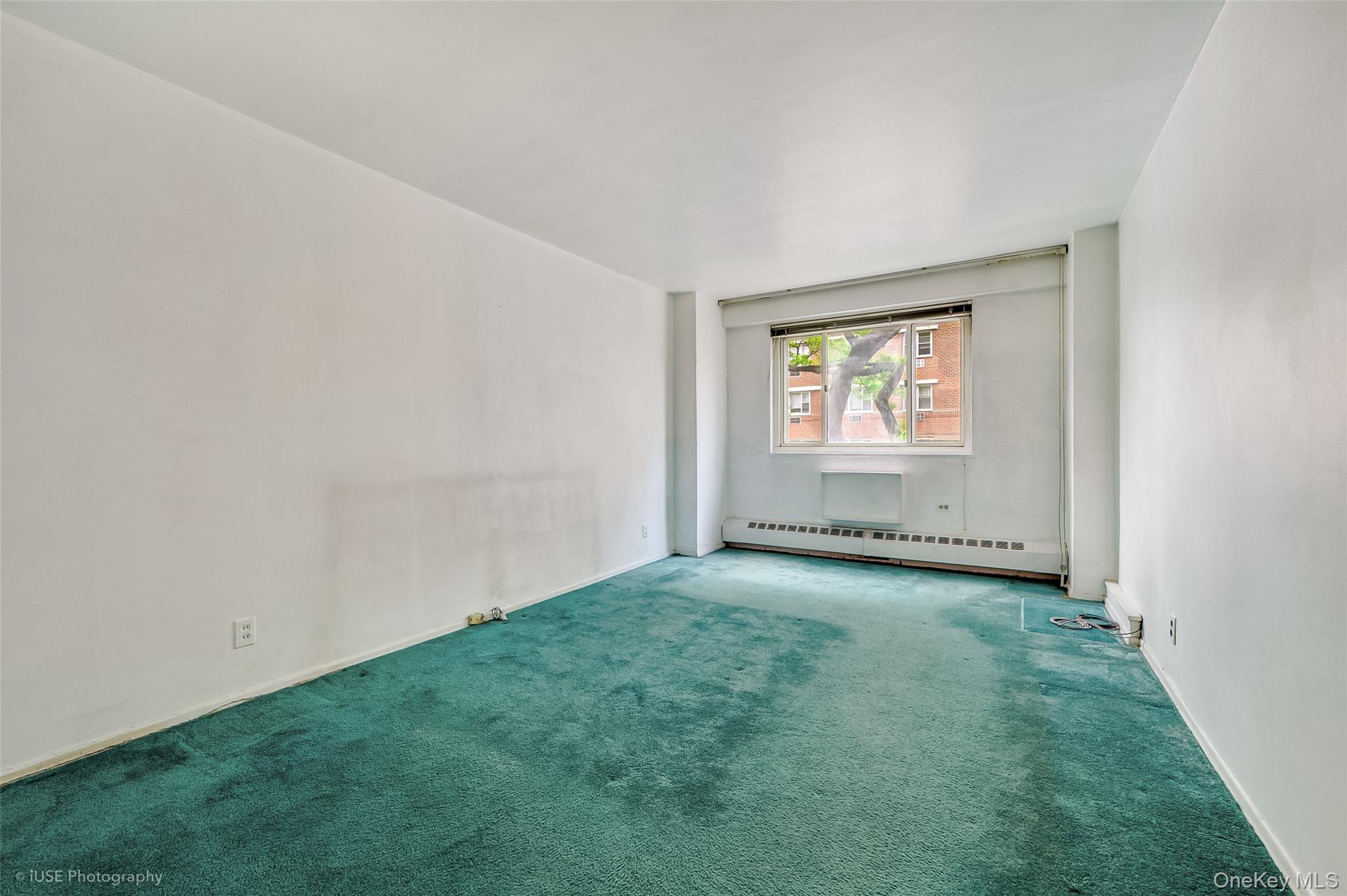 39-65 52nd Street, Unit 2H Queens, NY 11377 - Photo 10 of 18 an empty room with windows