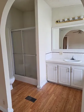 a view of kitchen with granite countertop cabinets and sink