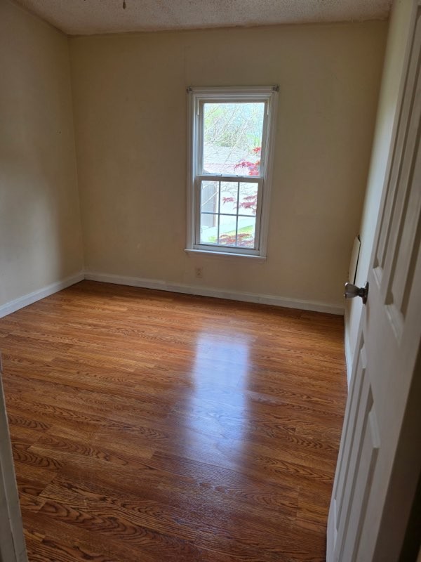 225 East Prospect Road Fayetteville, TN 37334 - Photo 6 of 11 a view of an empty room with wooden floor and a window