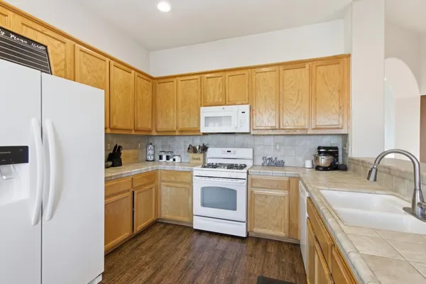 a kitchen with a sink cabinets stainless steel appliances and a window
